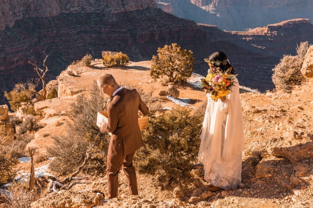 Couple hiking down Moran Point to prepare for their Grand Canyon intimate wedding ceremony