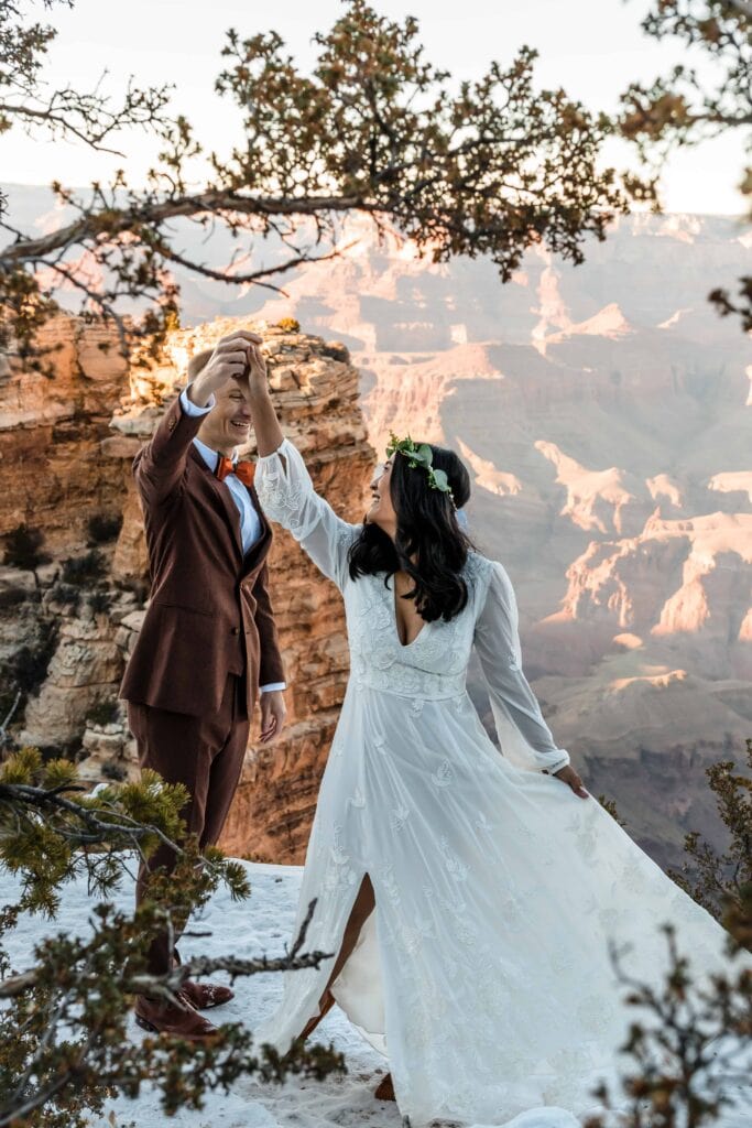 Groom spinning bride in front of the Grand Canyon South Rim