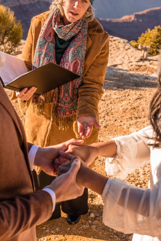 Exchanging rings during ceremony at Grand Canyon