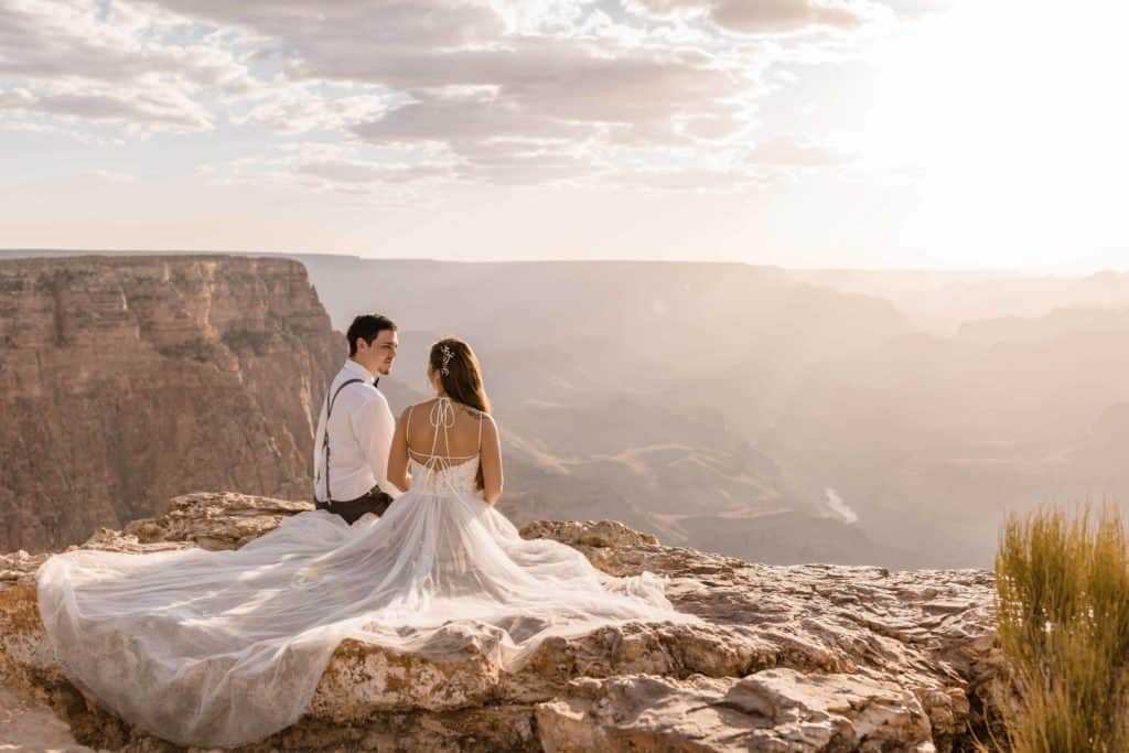 Bride and groom watching the sunset elopement at the Grand Canyon National Park South Rim in Page Arizona