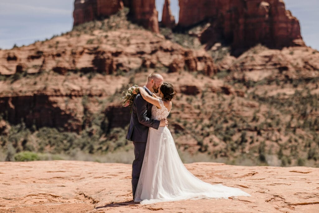 Bride and groom kissing at Secret Slick Rock in Sedona Arizona during their elopement