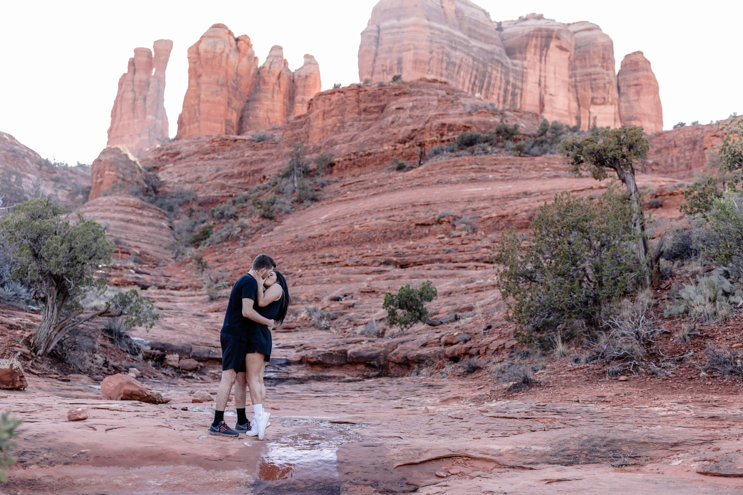 Adventurous couple hiking in Sedona for their Cathedral Rock Engagement Photos