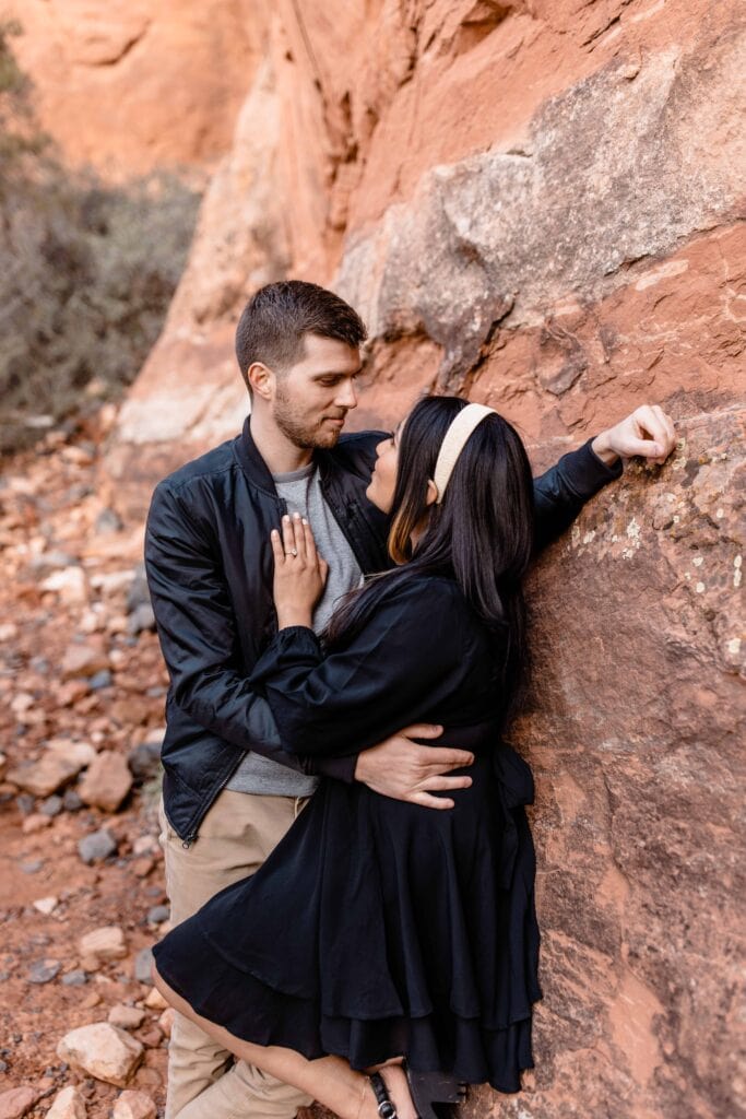 Adventurous couple hiking in Sedona for their Cathedral Rock Sunset Engagement Photos
