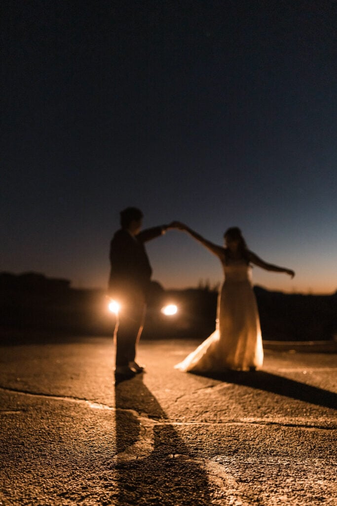 couple twirls under the stars using stargazing elopement ideas