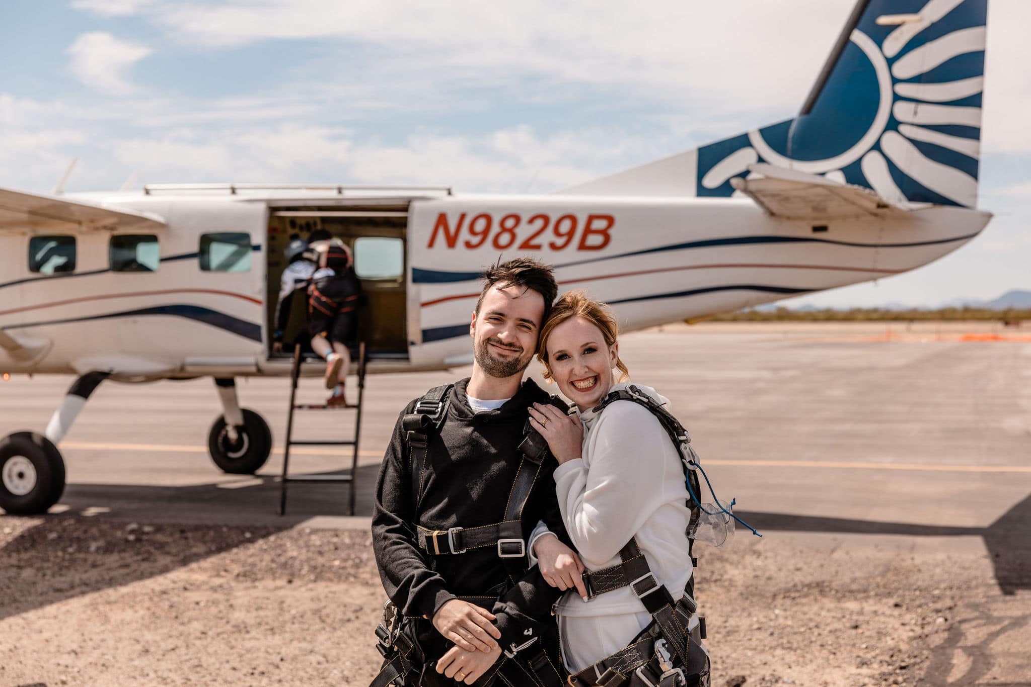 couple embraces for skydiving adventure elopement