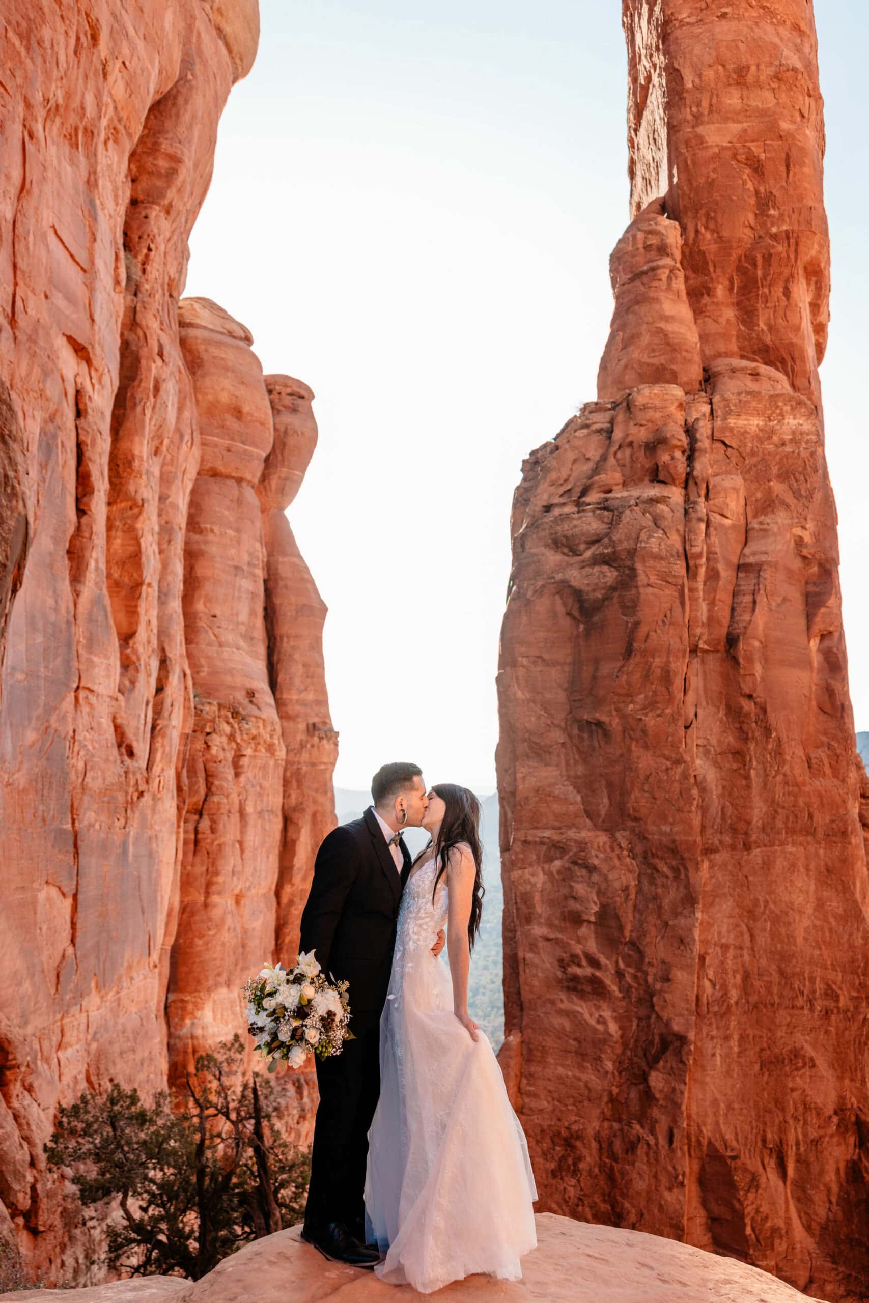 couple kisses at outdoor elopement