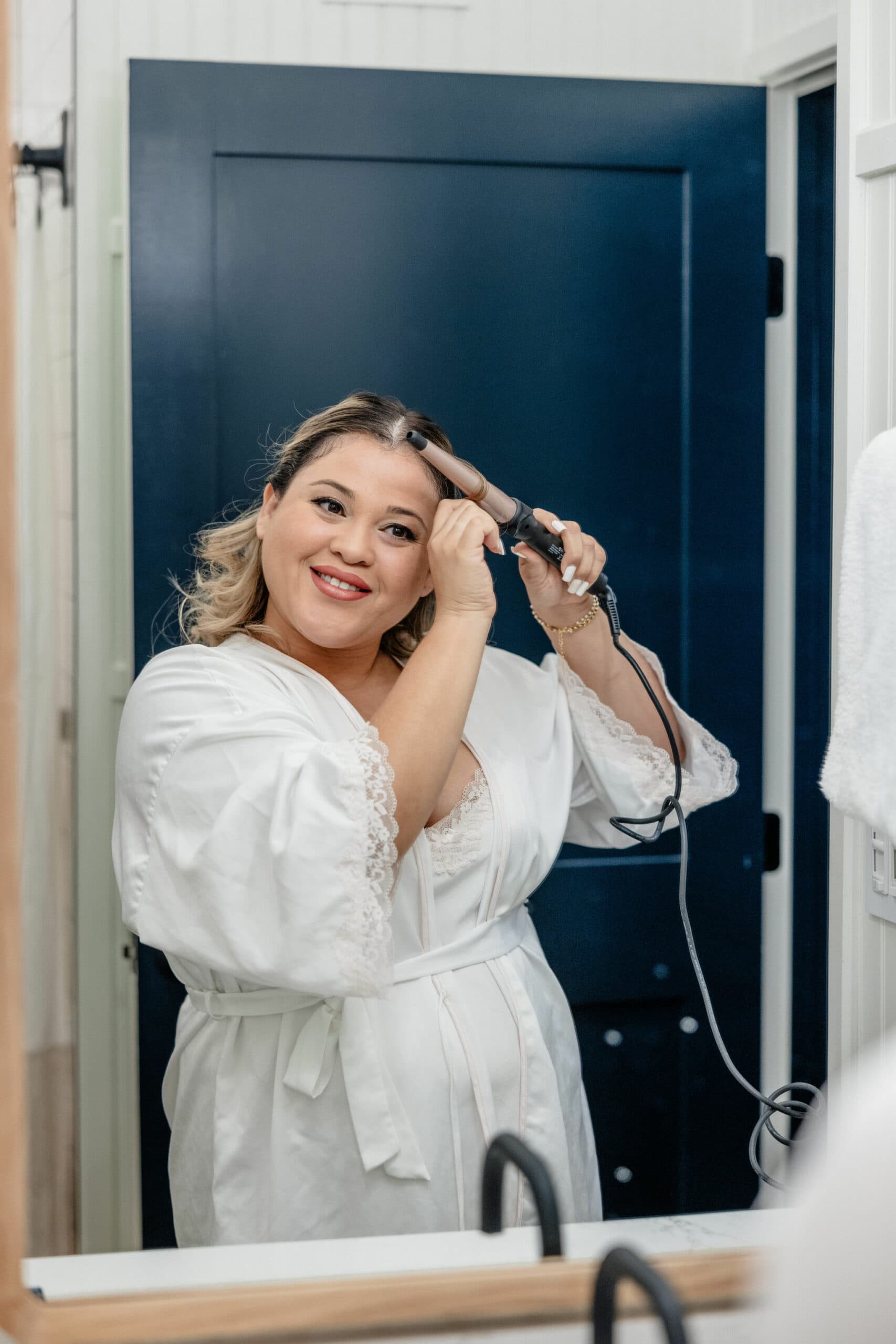 bride curls her own hair on elopement day