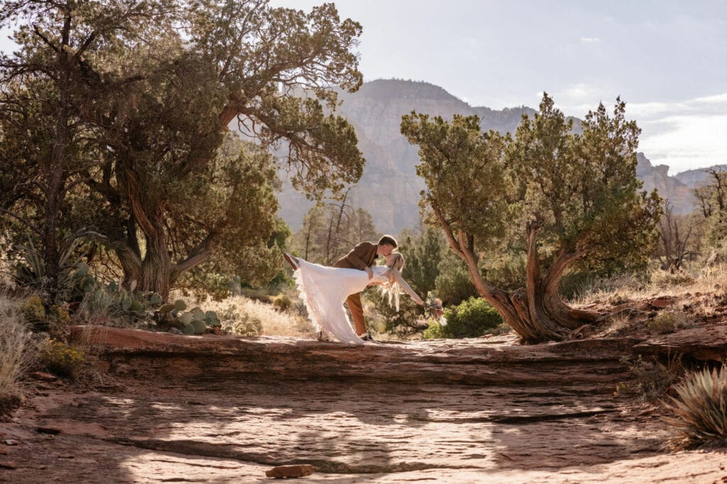 groom dips bride at outdoor Sedona Arizona sunrise elopement