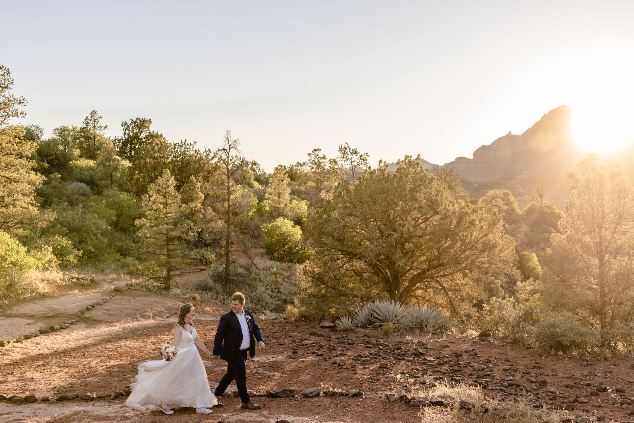 couple walks along path at sunset Flagstaff Arizona outdoor elopement location