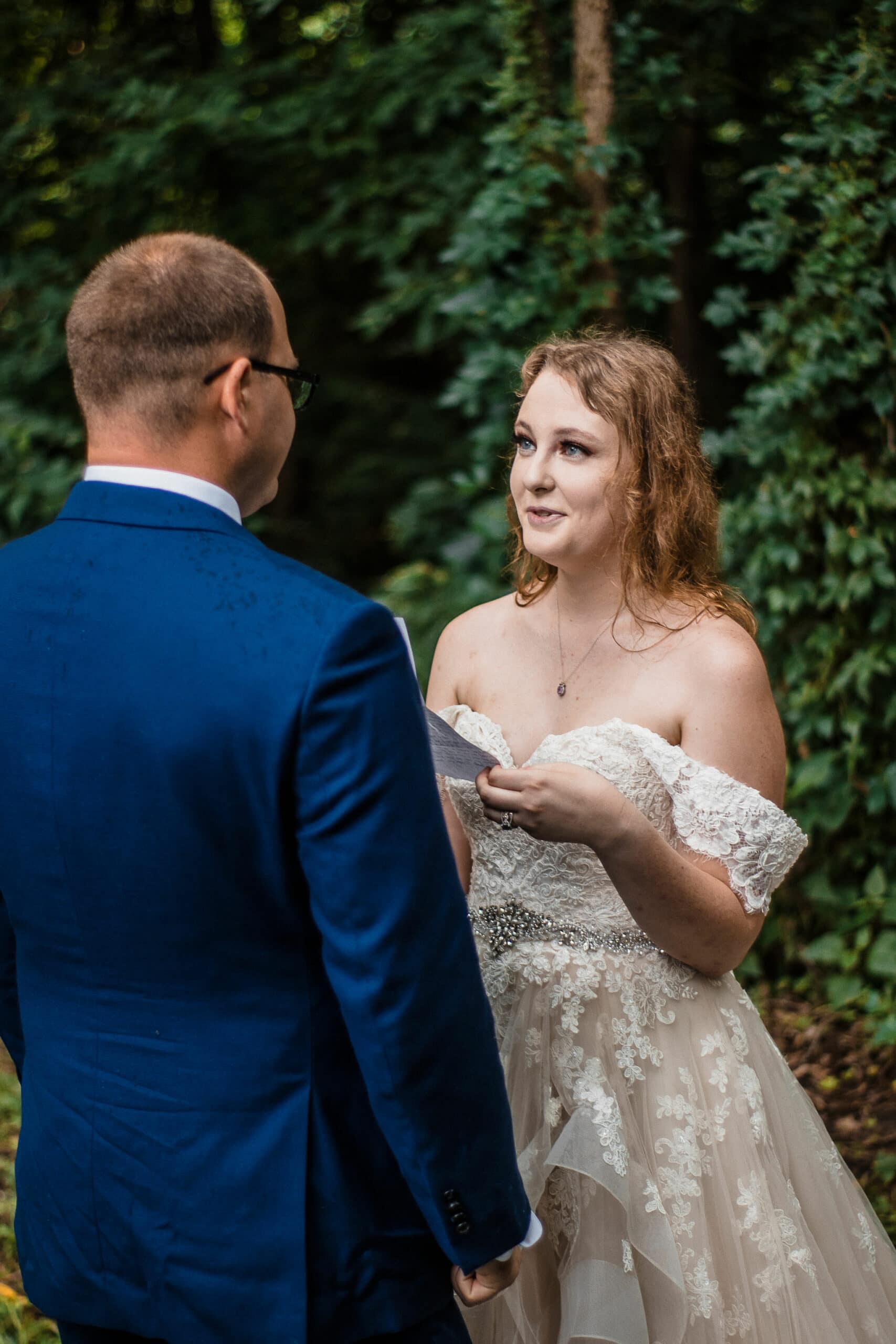 couple exchanges vows at forest sunset elopement location