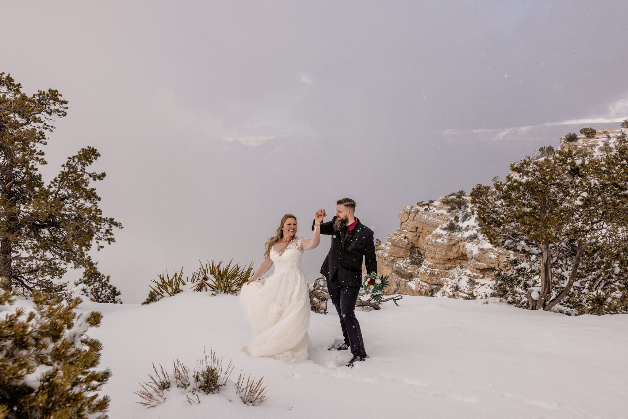 couple twirls in snow at Grand Canyon elopement location